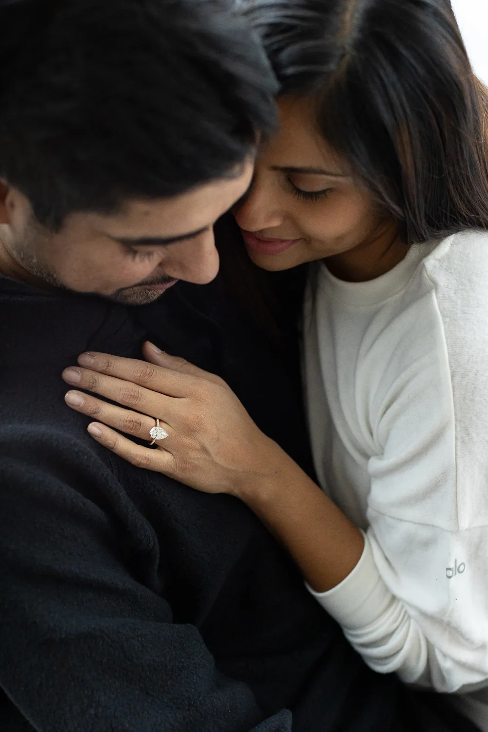 Engaged couple in Atlanta holding each other with engagement ring