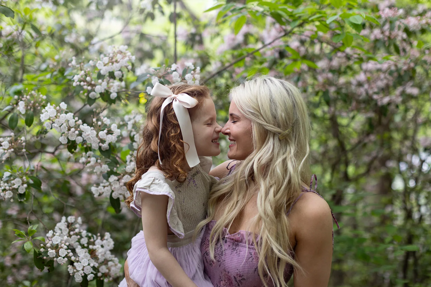 Mom and daughter rub noses in Spring in Roswell