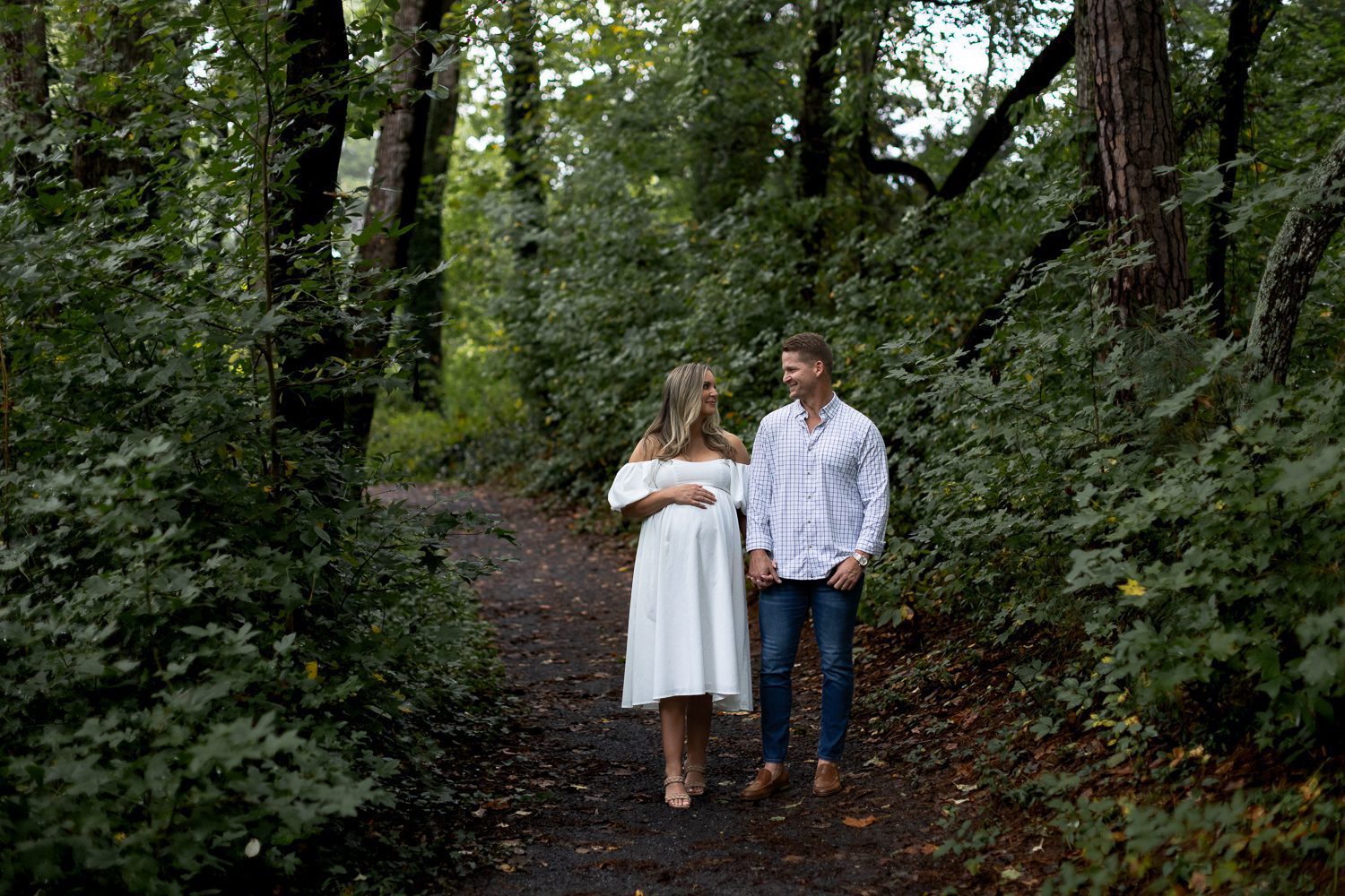 pregnant couple walking in mabry park in roswell