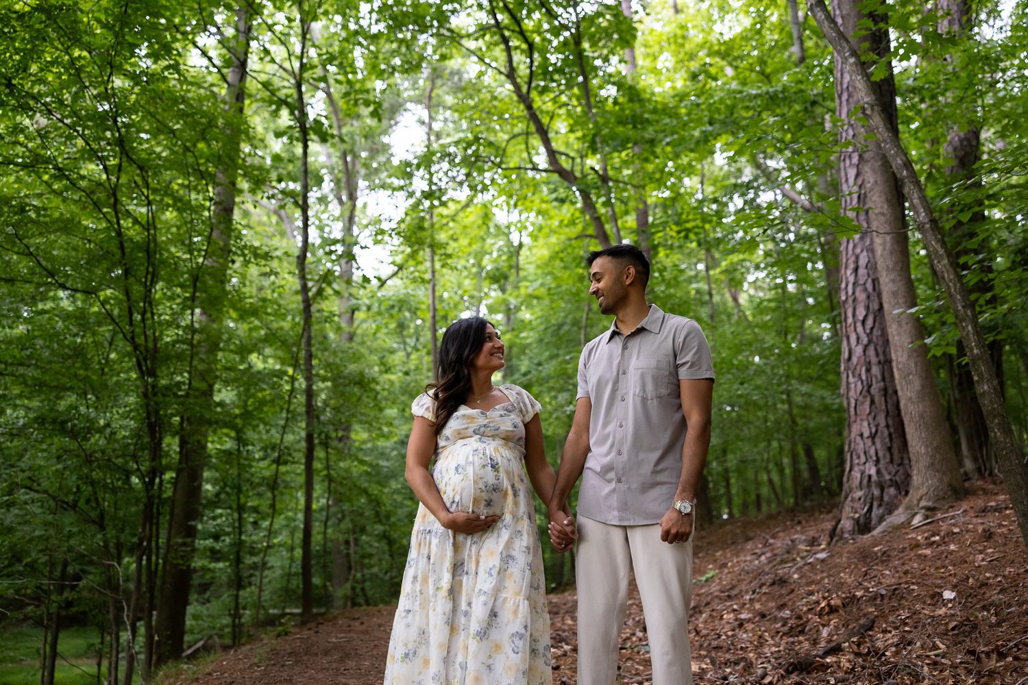 Expecting couple walking together during Brookhaven family maternity session